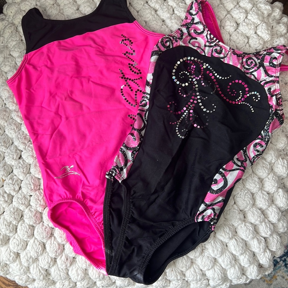 2 gymnastics leotards made by motion works.